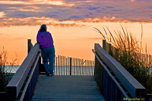 Woman watching sunrise Bethany Beach
